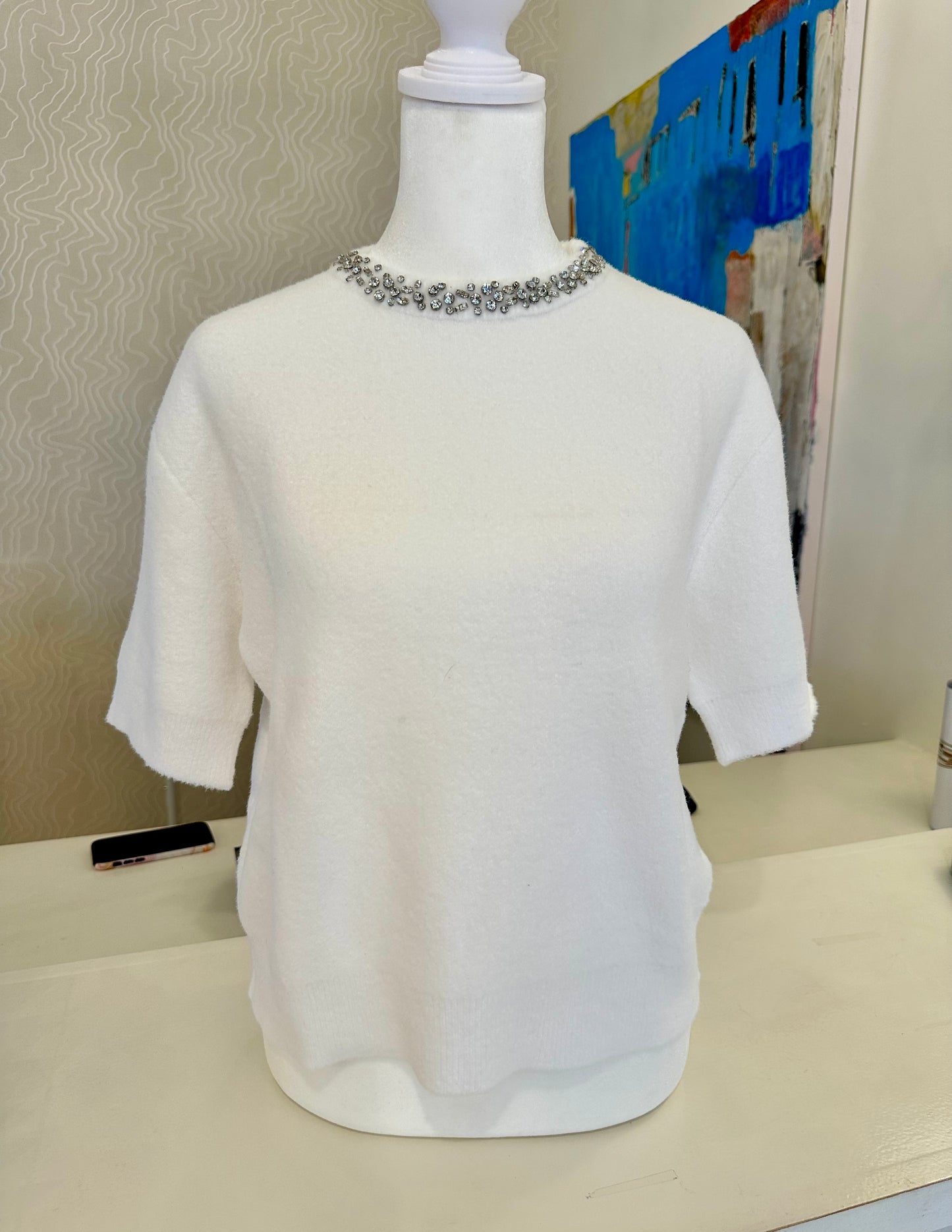 Ivory knit sweater with jeweled neckline